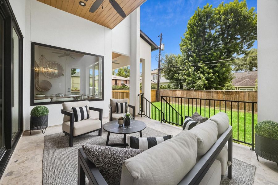 Another angle of the covered patio showcases the backyard connection, offering a comfortable outdoor setting for relaxing, dining, or entertaining. Another angle of the covered patio showcases the backyard connection, offering a comfortable outdoor setting for relaxing, dining, or entertaining.