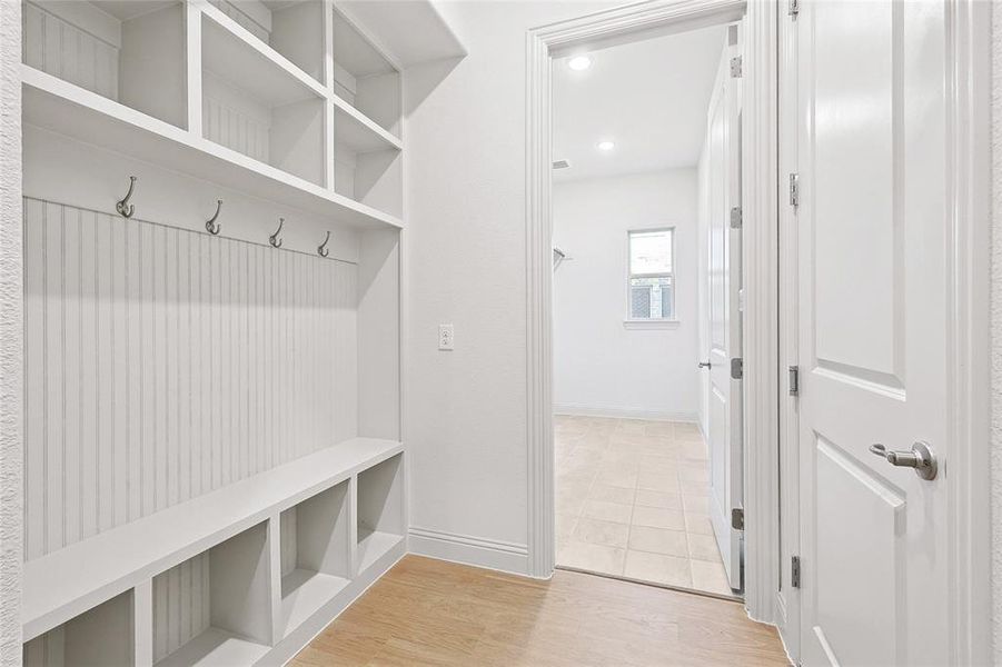 Mudroom featuring light tile flooring