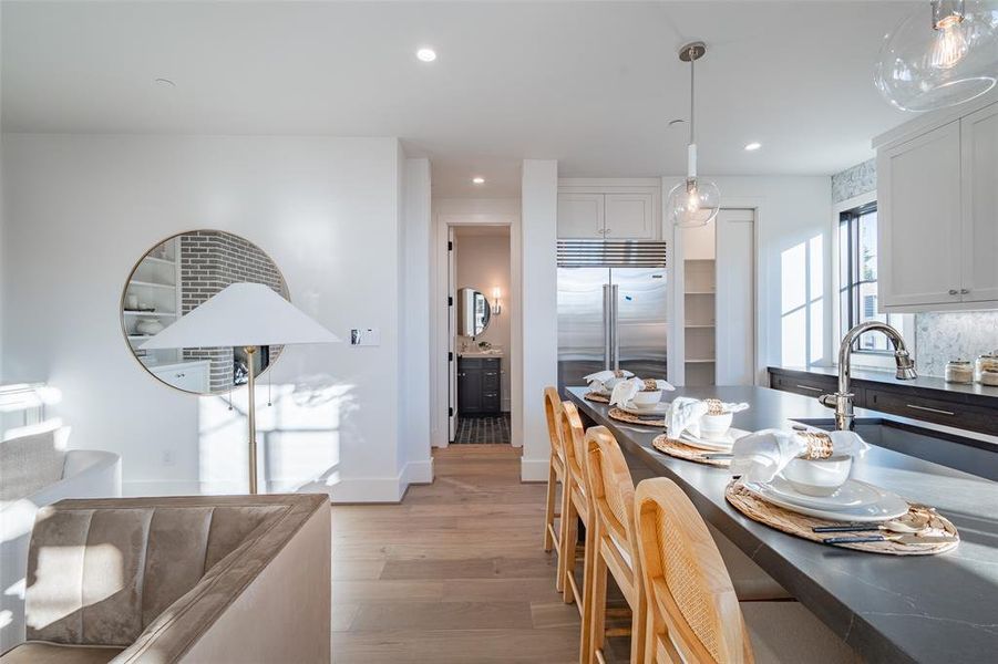 Dining room with light hardwood / wood-style flooring and sink