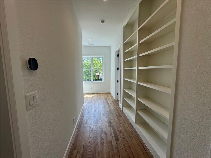 Corridor featuring hardwood / wood-style flooring