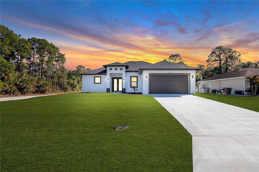 Front exterior of a new home in , Lehigh Acres, FL, highlighting curb appeal (Image 1). Front exterior of a new home in , Lehigh Acres, FL, highlighting curb appeal (Image 1).