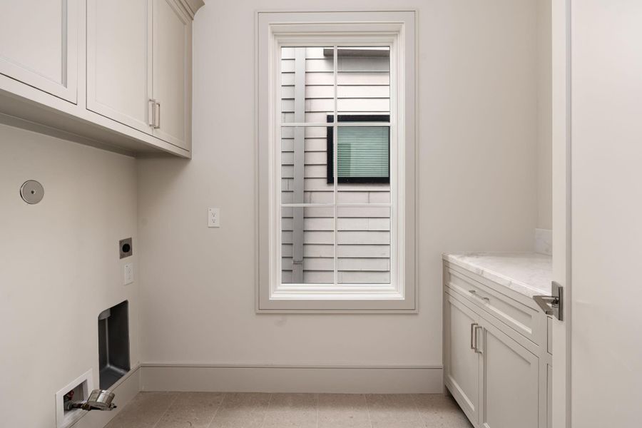 The large laundry room features gas and electric hook up for your full-sized washer and dryer, as well as marble-topped folding counter, storage cabinetry, and utility sink. The large laundry room features gas and electric hook up for your full-sized washer and dryer, as well as marble-topped folding counter, storage cabinetry, and utility sink.