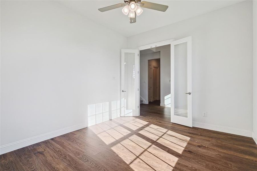 Unfurnished room featuring ceiling fan and wood-type flooring