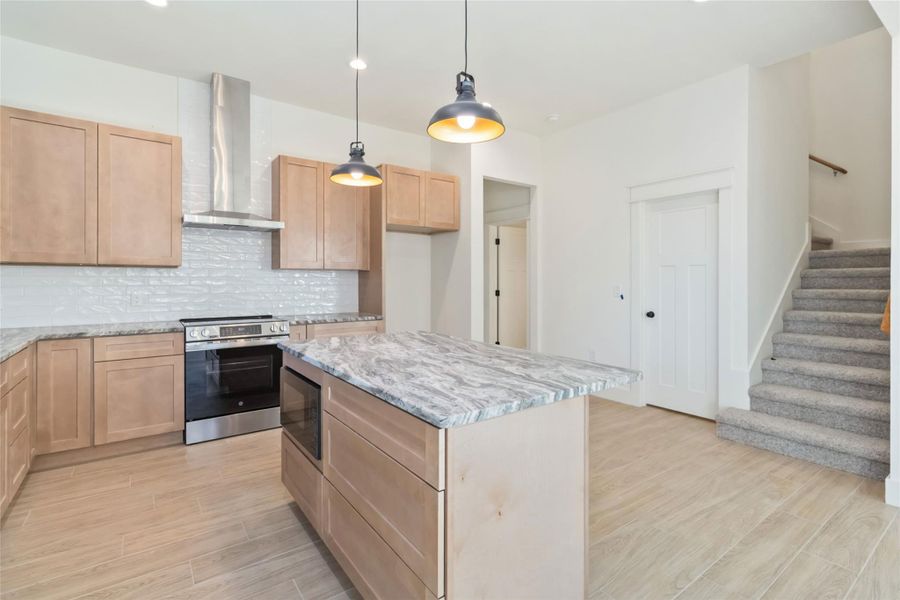 Microwave built into the lower cabinet and stainless steel Viking Vent Hood. View of stairs to upper level and pantry Microwave built into the lower cabinet and stainless steel Viking Vent Hood. View of stairs to upper level and pantry
