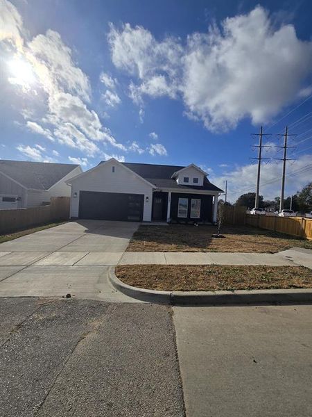 View of front of property with concrete driveway and a garage
