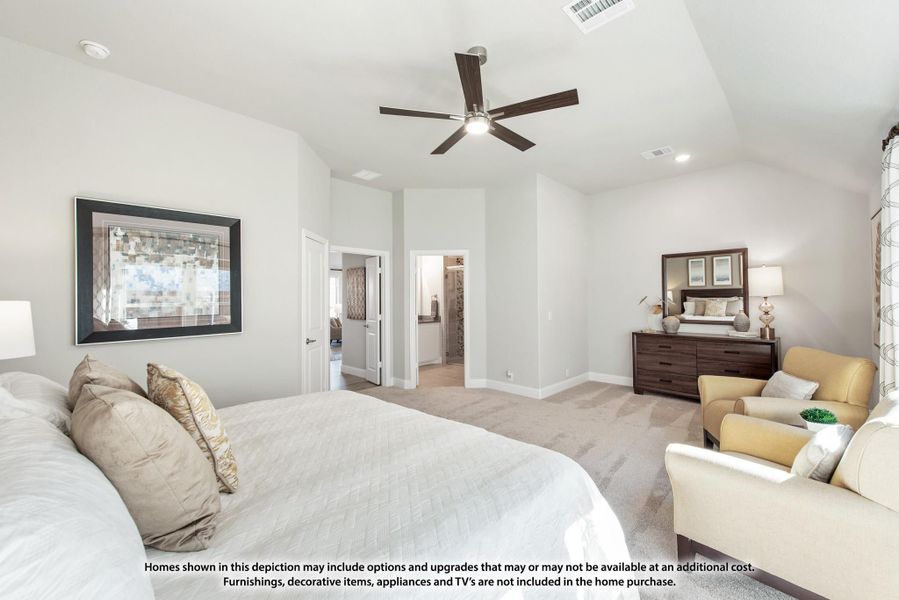 Spacious master bedroom with vaulted ceiling, ceiling fan, carpet flooring, and seating area near ensuite bathroom door. Spacious master bedroom with vaulted ceiling, ceiling fan, carpet flooring, and seating area near ensuite bathroom door.