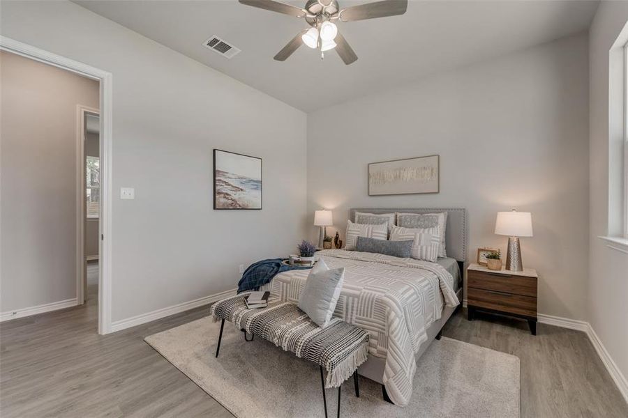 Bedroom with ceiling fan and light hardwood / wood-style floors