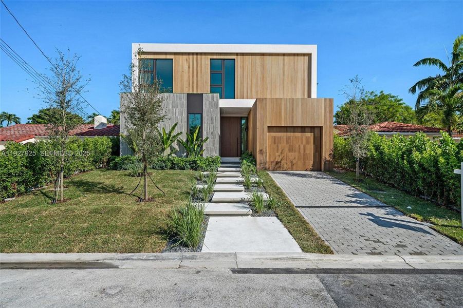 Front exterior of a new home in , Surfside, FL, highlighting curb appeal (Image 1). Front exterior of a new home in , Surfside, FL, highlighting curb appeal (Image 1).