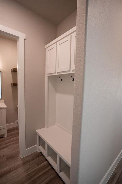 Mudroom with dark wood finished floors and baseboards Mudroom with dark wood finished floors and baseboards