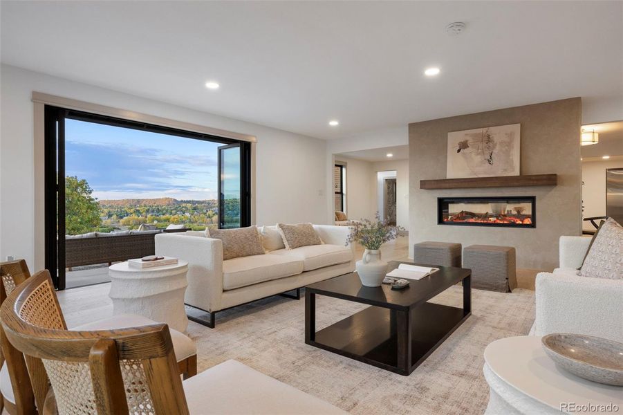 Living room with folding doors and a 50 inch see through gas fireplace