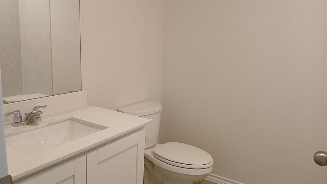 Modern vanity featuring a white rectangular under-mount sink, chrome faucet, and white countertop Modern vanity featuring a white rectangular under-mount sink, chrome faucet, and white countertop