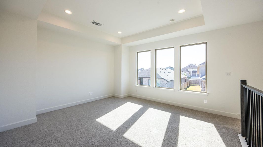 Spare room featuring light colored carpet, recessed lighting, and a raised ceiling Spare room featuring light colored carpet, recessed lighting, and a raised ceiling