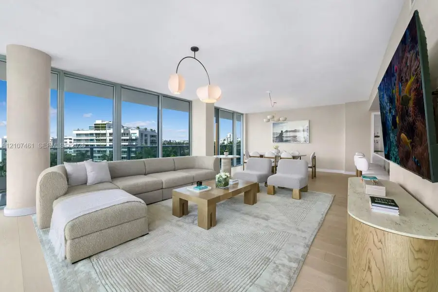 Floor-to-ceiling glass walls, light-toned wood-finish flooring, architectural structural columns, and modern designer light fixtures Floor-to-ceiling glass walls, light-toned wood-finish flooring, architectural structural columns, and modern designer light fixtures