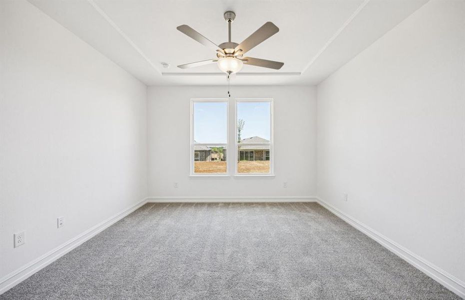 Spacious owner's suite highlighted by large windows and an exquisite tray ceiling *Real home pictured Spacious owner's suite highlighted by large windows and an exquisite tray ceiling *Real home pictured
