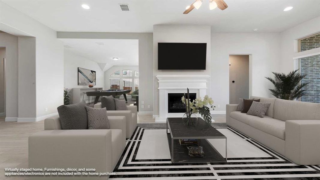 Living room featuring ceiling fan and light hardwood / wood-style flooring