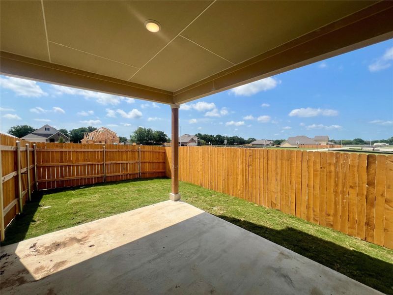 Fenced backyard with a patio area