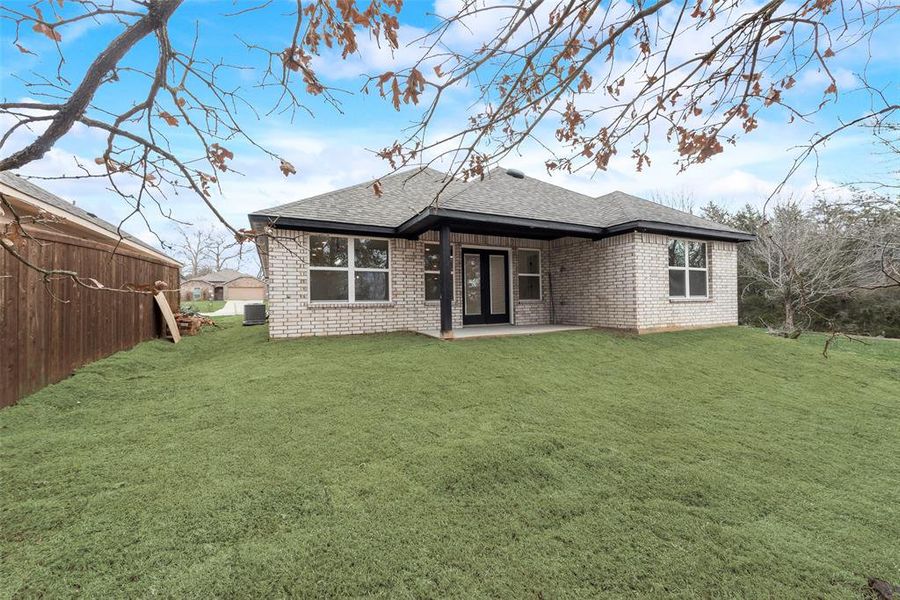 Back of property featuring central AC, a yard, and a patio