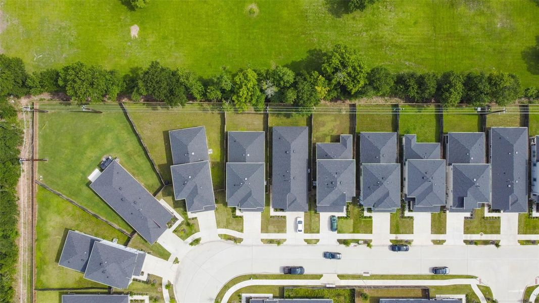 A top-down drone view reveals the organized, clean-lined symmetry of this residential street, with fenced backyards, neatly aligned driveways, and generous spacing between homes. It’s a community designed for privacy, functionality, and everyday comfort. A top-down drone view reveals the organized, clean-lined symmetry of this residential street, with fenced backyards, neatly aligned driveways, and generous spacing between homes. It’s a community designed for privacy, functionality, and everyday comfort.