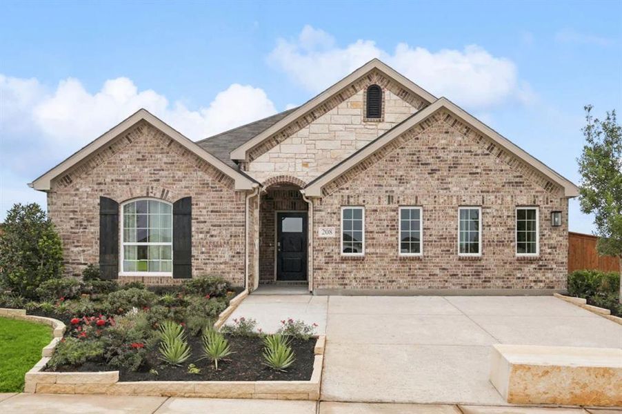 French country style house featuring brick siding