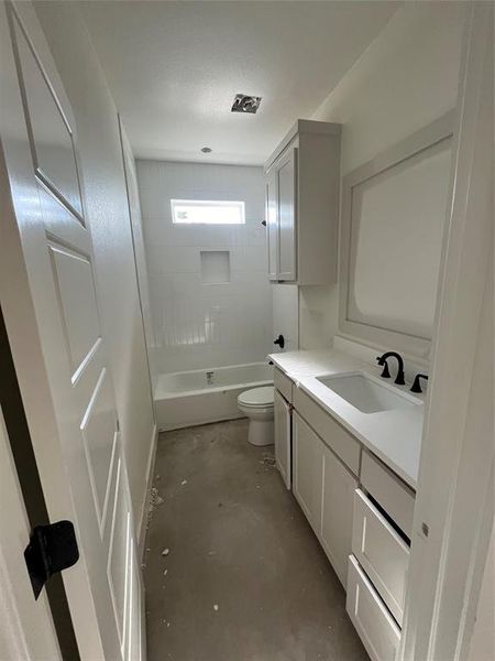 Full bathroom featuring vanity, shower / bath combination, concrete flooring, and toilet