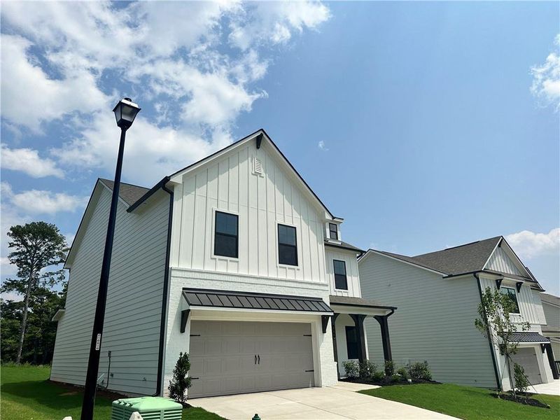 Front exterior of a new home in Summerlin, Winder, GA, highlighting curb appeal (Image 24). Front exterior of a new home in Summerlin, Winder, GA, highlighting curb appeal (Image 24).