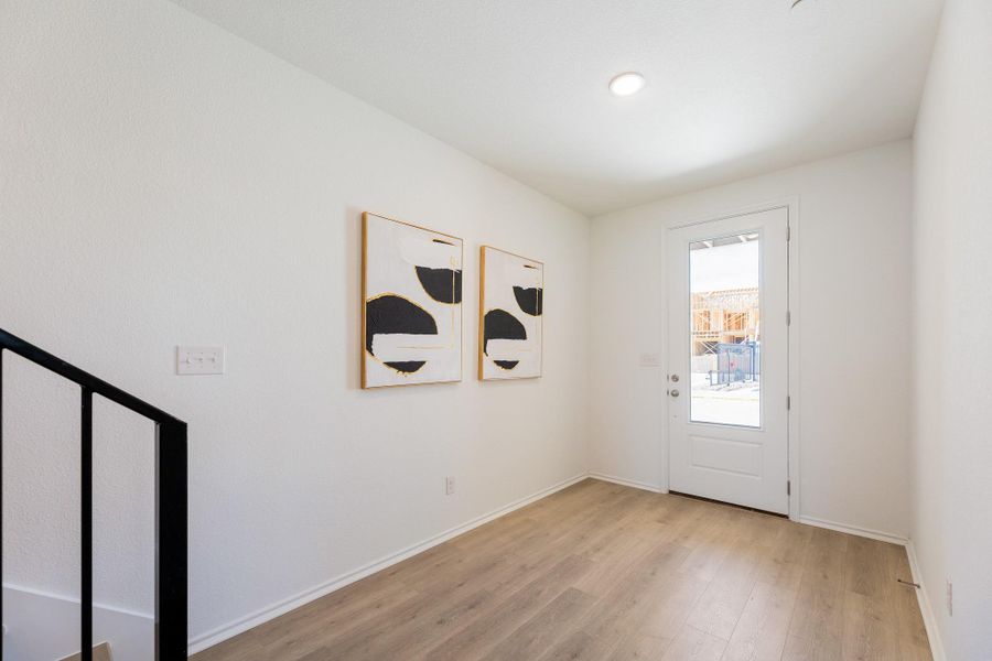 Foyer entrance with baseboards and light wood finished floors