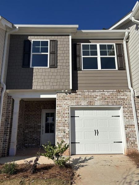 Exterior details and patio area of a home in The Reserve At Clock Tower, Douglasville (Image 1).