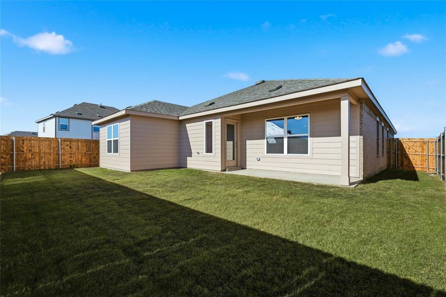 Back of house with a patio area, a fenced backyard, and a shingled roof