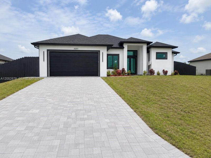 Front exterior of a new home in , Cape Coral, FL, highlighting curb appeal (Image 1). Front exterior of a new home in , Cape Coral, FL, highlighting curb appeal (Image 1).