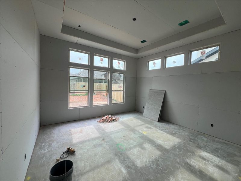 Empty room featuring a raised ceiling