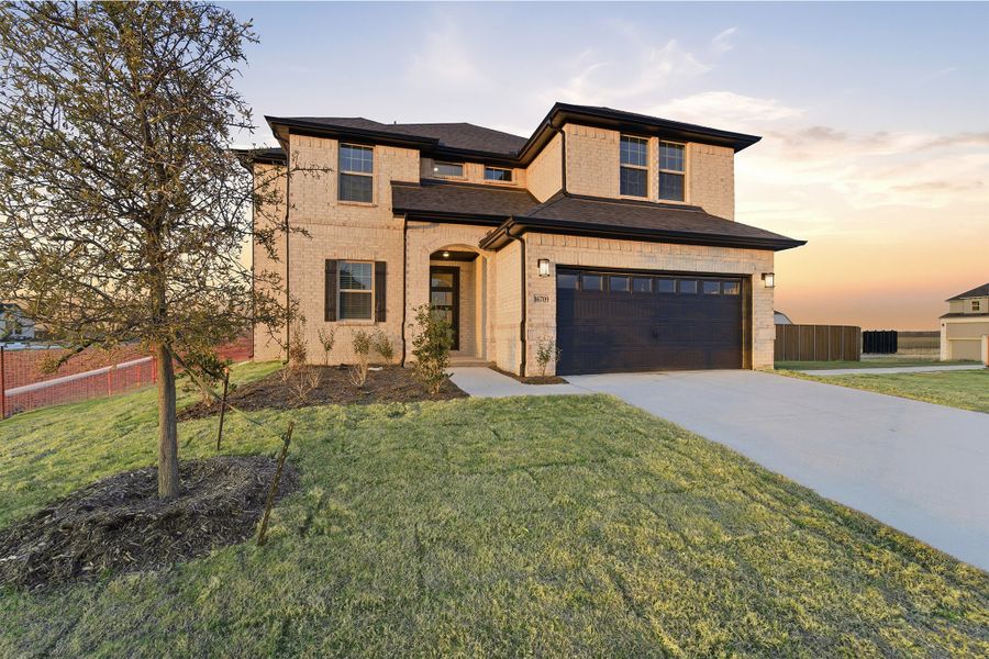 Front exterior of a new home in Green Meadows, Celina, TX, highlighting curb appeal (Image 2). Front exterior of a new home in Green Meadows, Celina, TX, highlighting curb appeal (Image 2).
