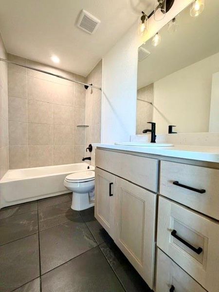 A well-appointed bathroom features a practical vanity and a refreshing shower-tub combination. A well-appointed bathroom features a practical vanity and a refreshing shower-tub combination.