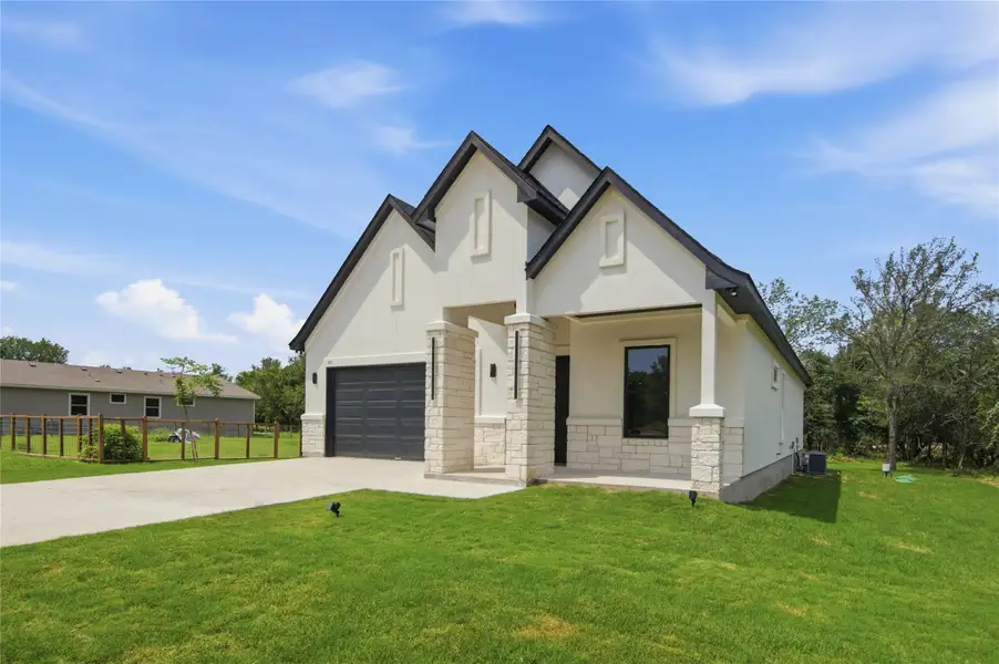 A striking modern facade with contrasting roof lines and stone accents. A striking modern facade with contrasting roof lines and stone accents.