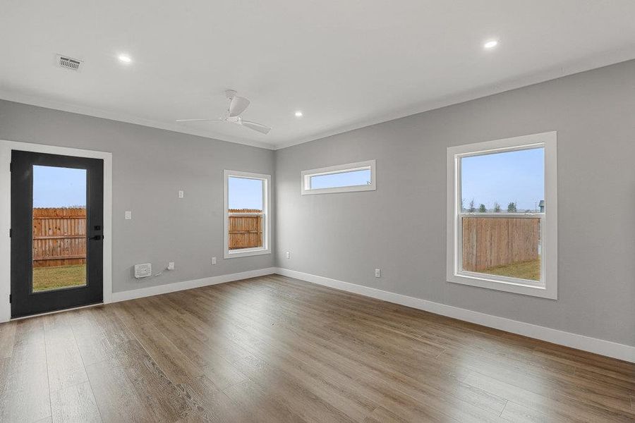 Unfurnished room with light wood-style flooring, recessed lighting, crown molding, and ceiling fan