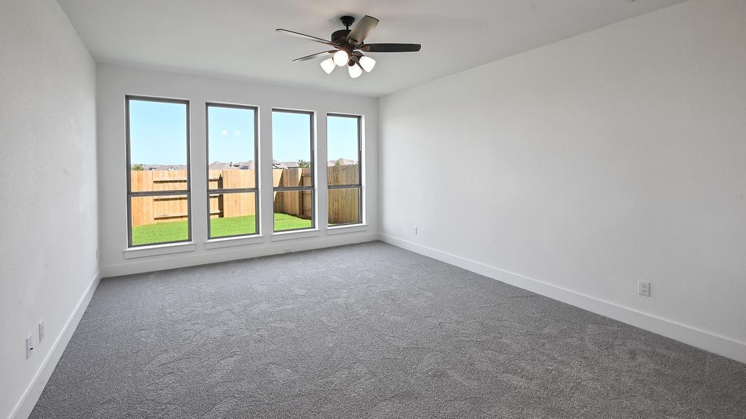 Spare room featuring carpet flooring and a ceiling fan Spare room featuring carpet flooring and a ceiling fan