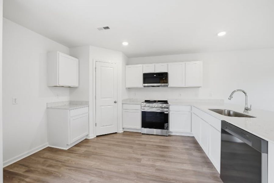 A kitchen with white cabinets. A kitchen with white cabinets.
