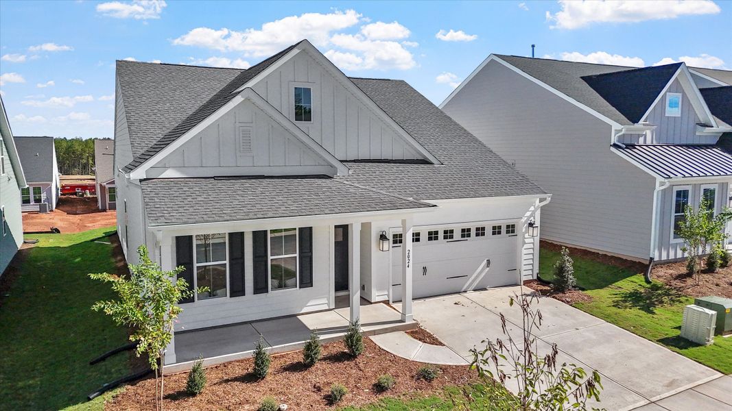 Front exterior of a new home in Ovation at Sweetbrier, Durham, NC, highlighting curb appeal (Image 19).