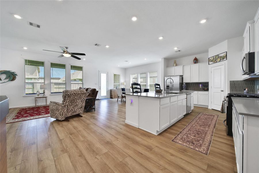 Easy to maintain flooring and granite counter tops grace this common space