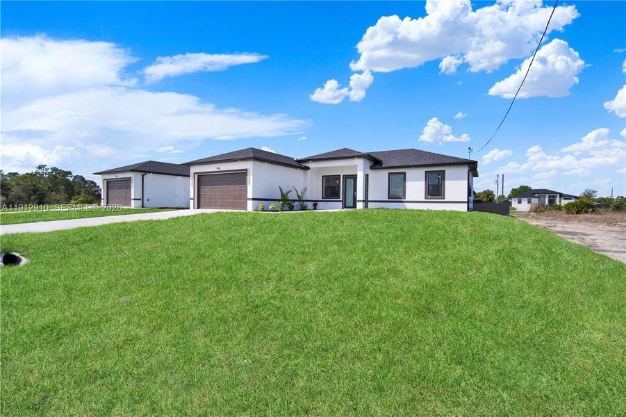 Front exterior of a new home in , Lehigh Acres, FL, highlighting curb appeal (Image 14).