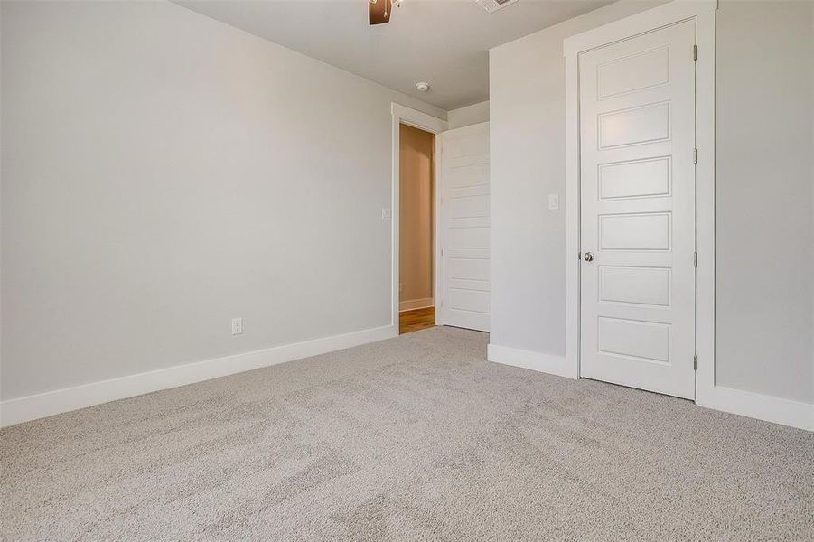 Unfurnished bedroom featuring carpet floors and ceiling fan