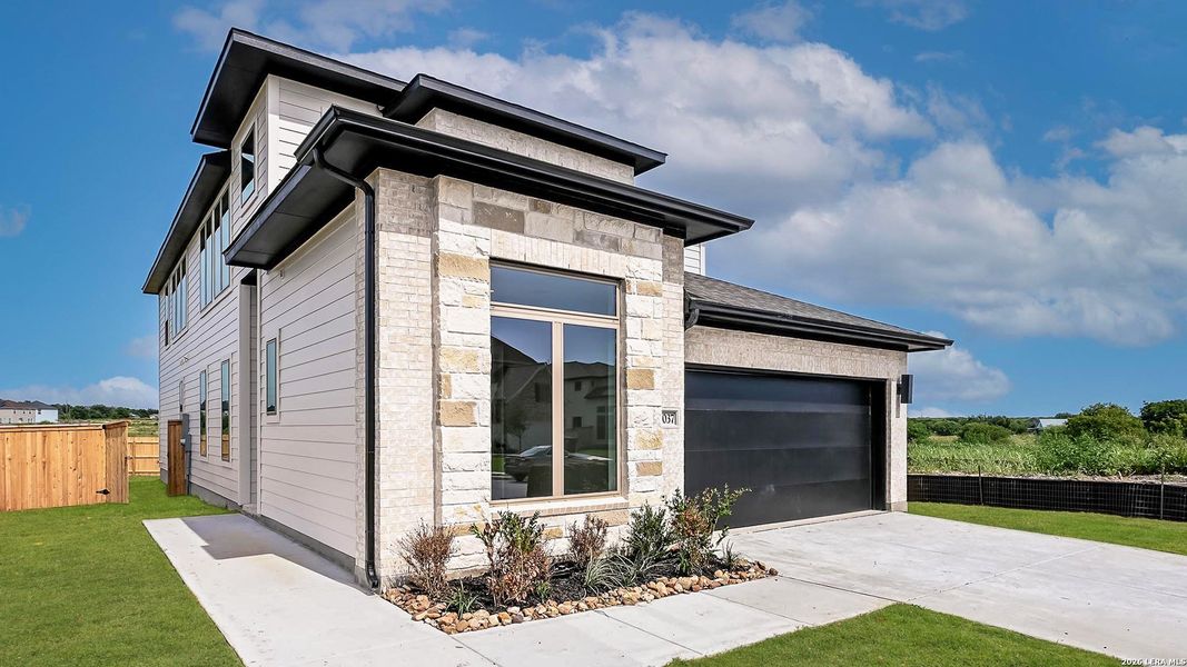 Front exterior of a new home in The Parklands, Schertz, TX, highlighting curb appeal (Image 21).