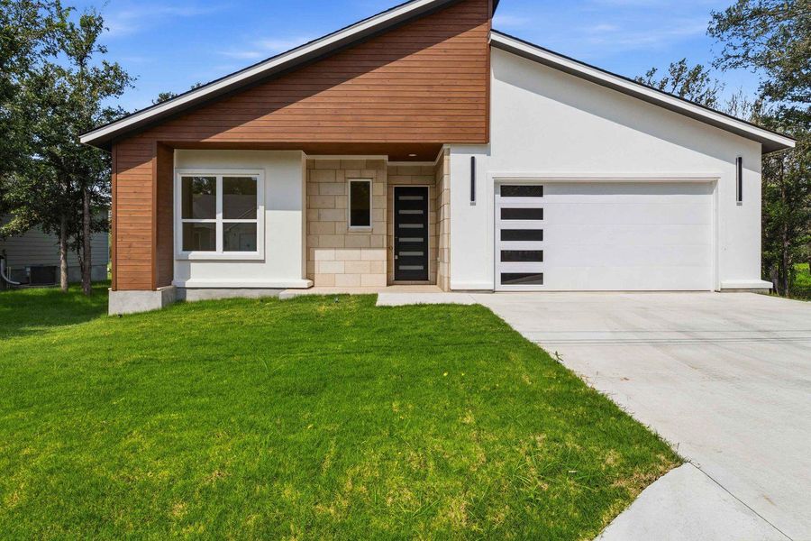 A modern facade with striking wood and stucco accents welcomes you home. A modern facade with striking wood and stucco accents welcomes you home.