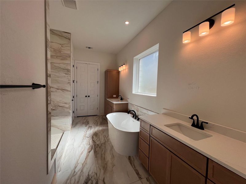Full bathroom with vanity, a soaking tub, light marble finish flooring, recessed lighting, and a marble finish shower
