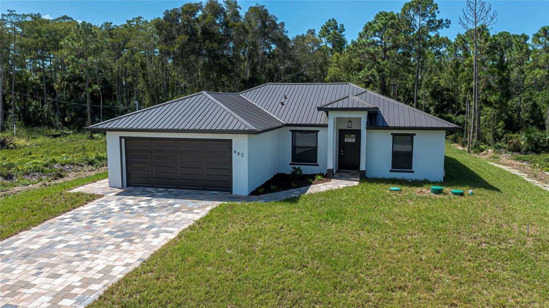 Front exterior of a new home in , Lehigh Acres, FL, highlighting curb appeal (Image 14).