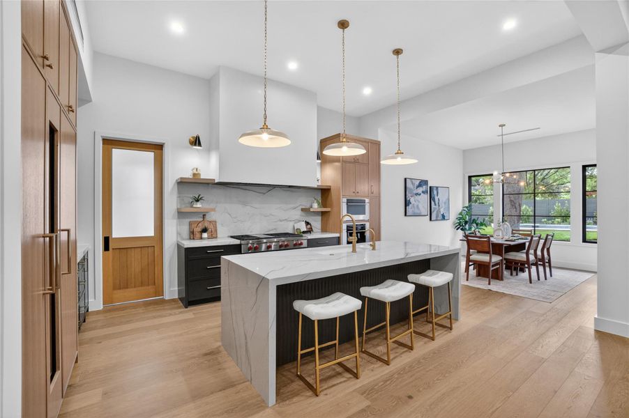 Culinary aspirations meet refined design in this sleek kitchen, perfect for entertaining.