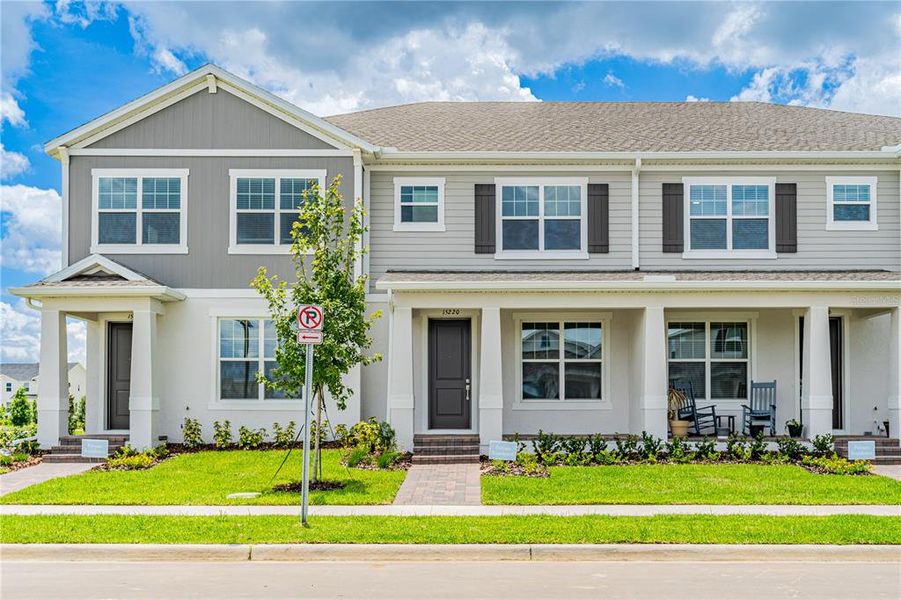 Front exterior of a new home in Osprey Ranch Townhomes, Winter Garden, FL, highlighting curb appeal (Image 19).