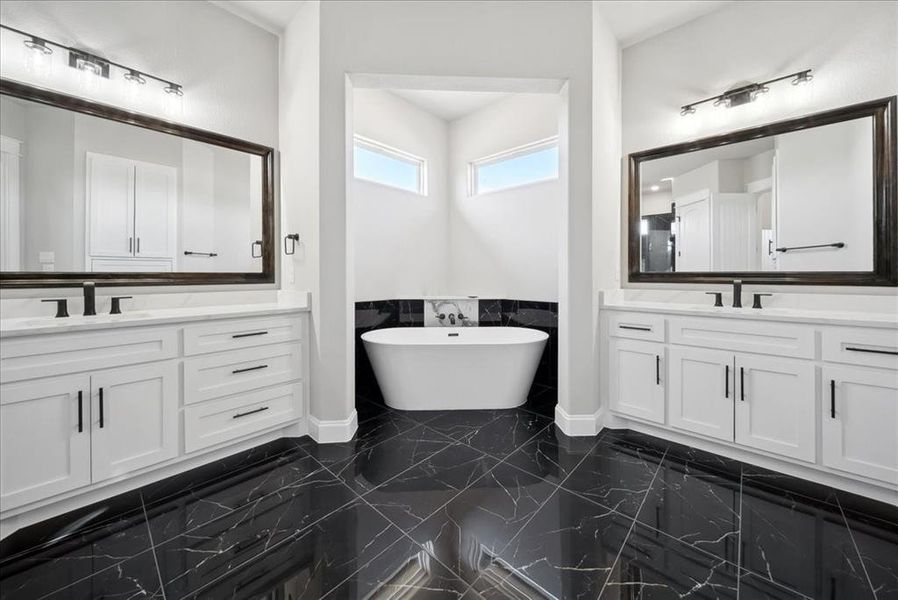 Bathroom featuring vanity and a tub