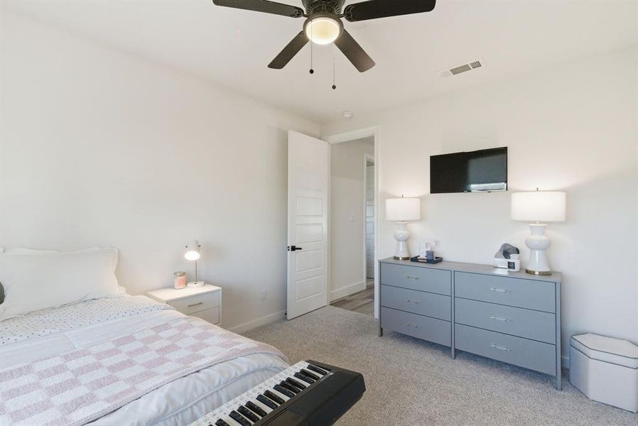 Bedroom featuring light carpet and a ceiling fan