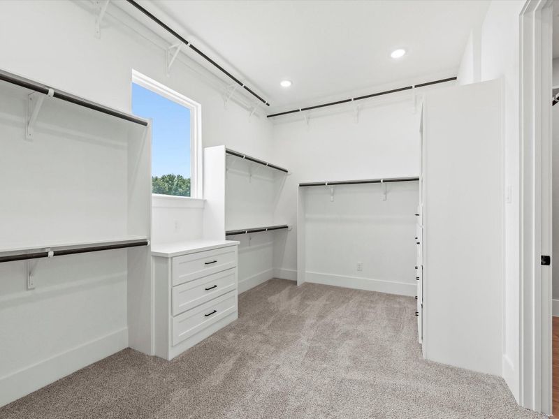 Primary closet featuring natural light and built in drawers. Primary closet featuring natural light and built in drawers.