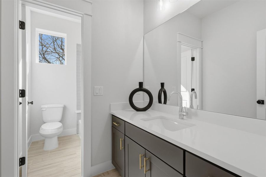 This elegant secondary bath features a sleek, modern design with a spacious vanity, contemporary fixtures, and abundant natural light, creating a serene and inviting atmosphere. This elegant secondary bath features a sleek, modern design with a spacious vanity, contemporary fixtures, and abundant natural light, creating a serene and inviting atmosphere.